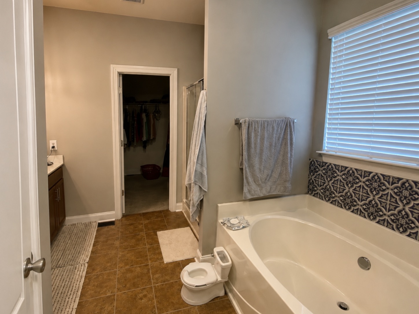 Before — dated bathroom with a built-in garden tub